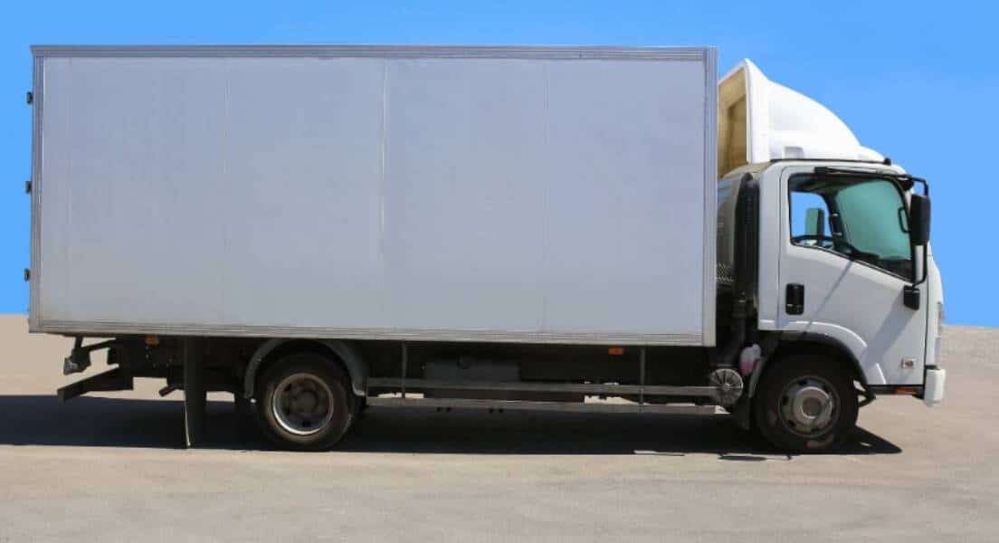 Side profile of a white truck that has box truck insurance.